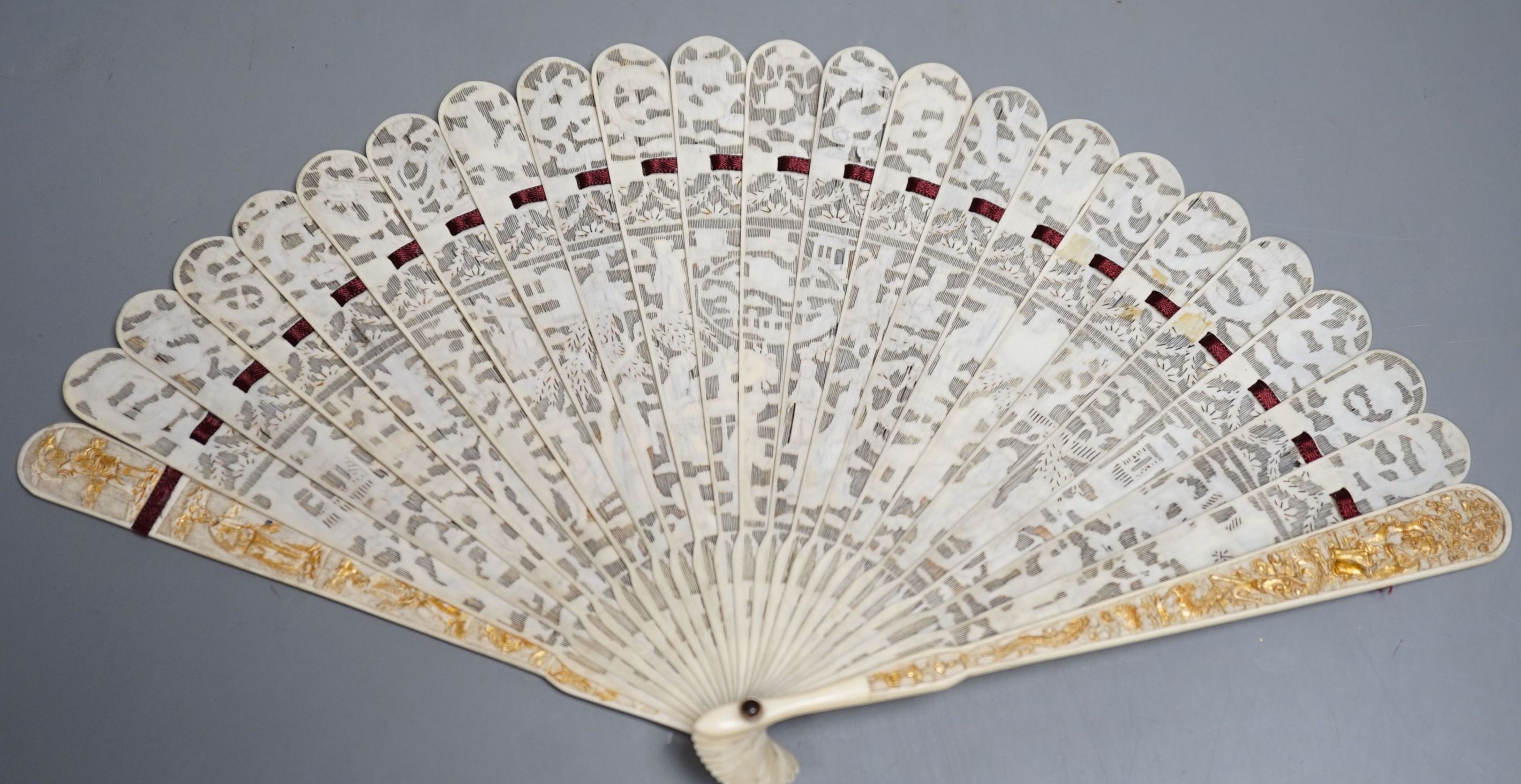 A 19th century Chinese export pierced ivory brise fan, gilded sticks, 19cm